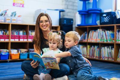teacher with preschoolers sitting on floor